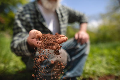Man showing soil in his hand